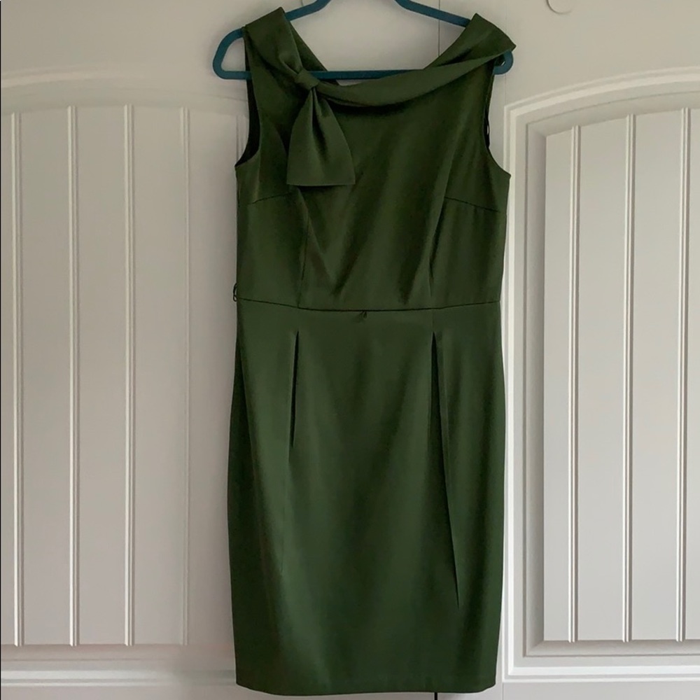 Green satin dress with bow detail.